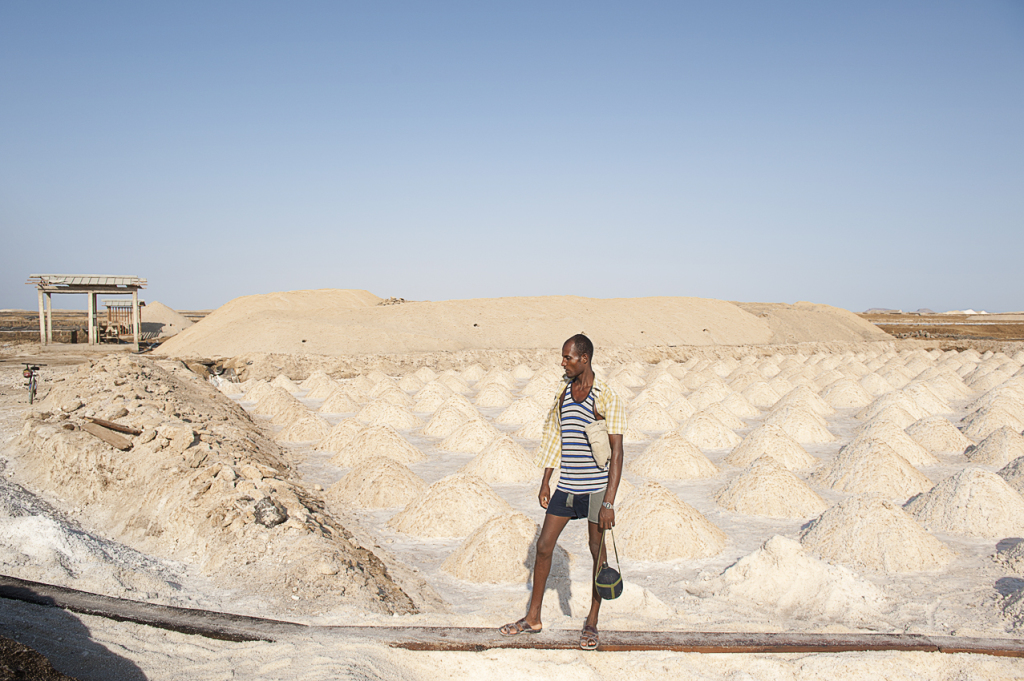 A worker in a salt pool at lake Afrera